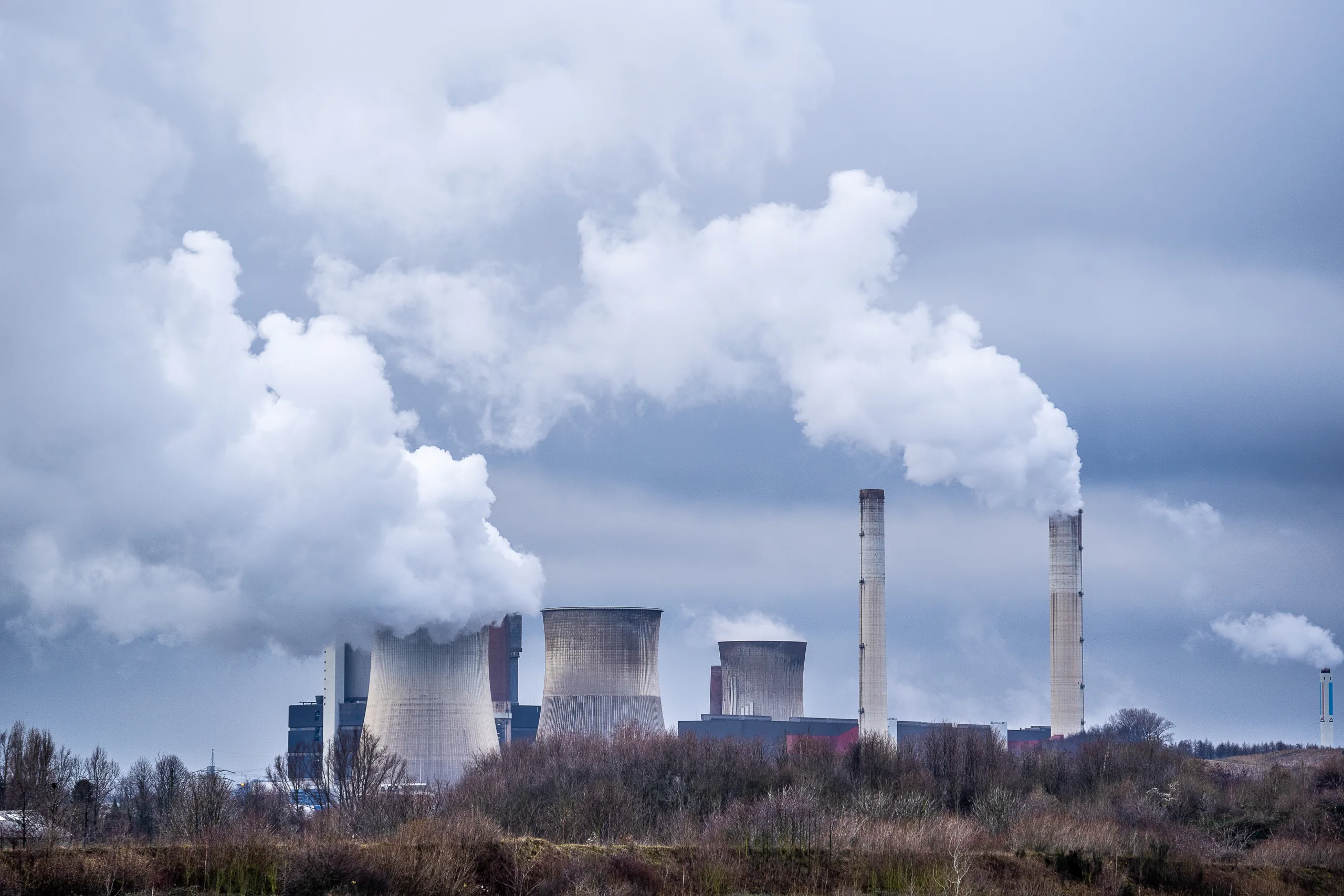 A wide angle shot of white smoke coming out of the nuclear plants